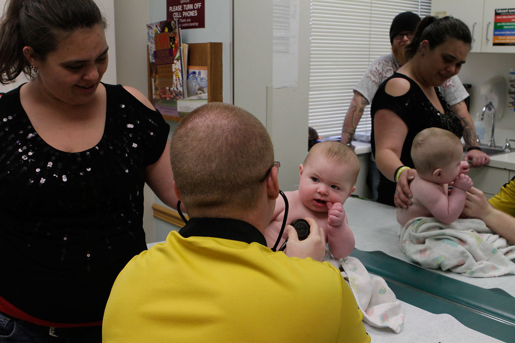 Nick Arnold checks the heartbeat of a 6-month-old